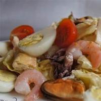 Simple salad with mussels, shrimp and tomatoes with mayonnaise